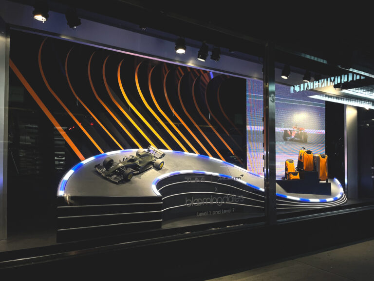Window Display of a Miniature F1 car and suitcases on a race track for the brand Tumi